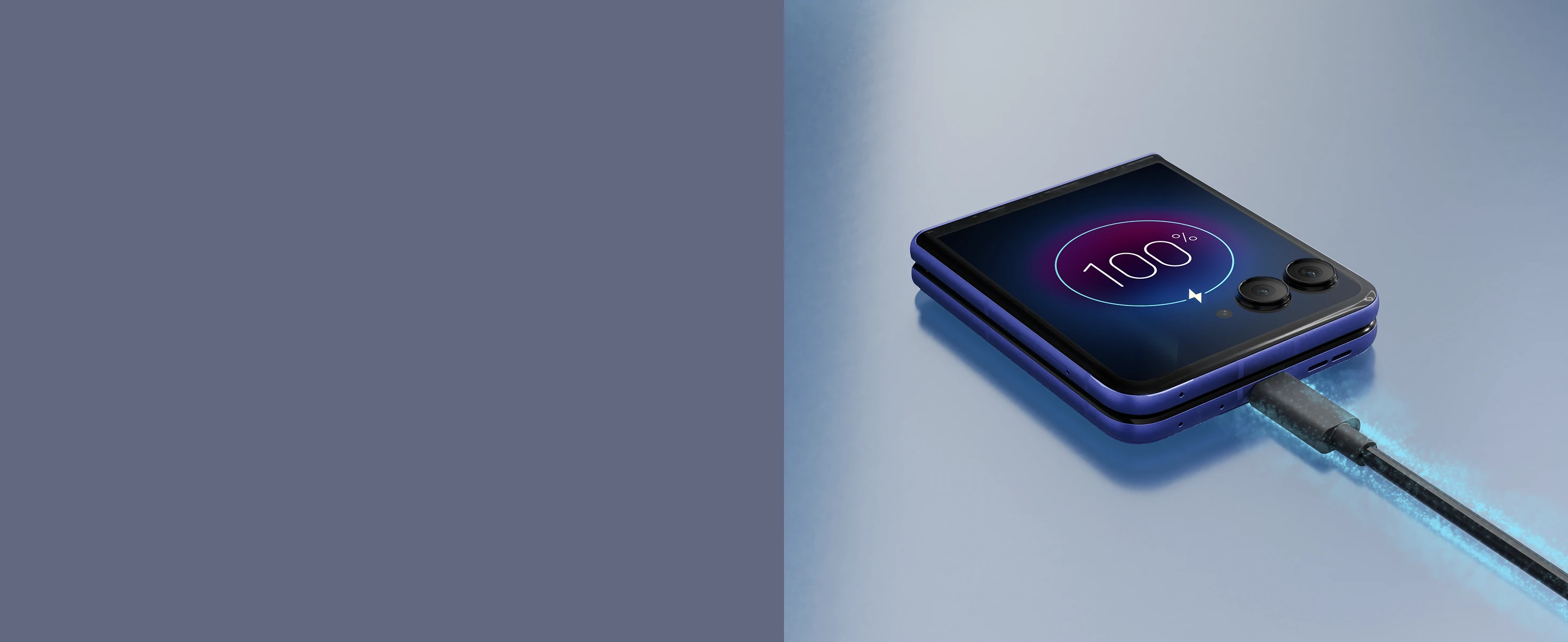 A blue foldable smartphone is laying closed on a reflective surface, connected to a charging cable with a glowing effect, and its small screen shows a full 100% battery charge.