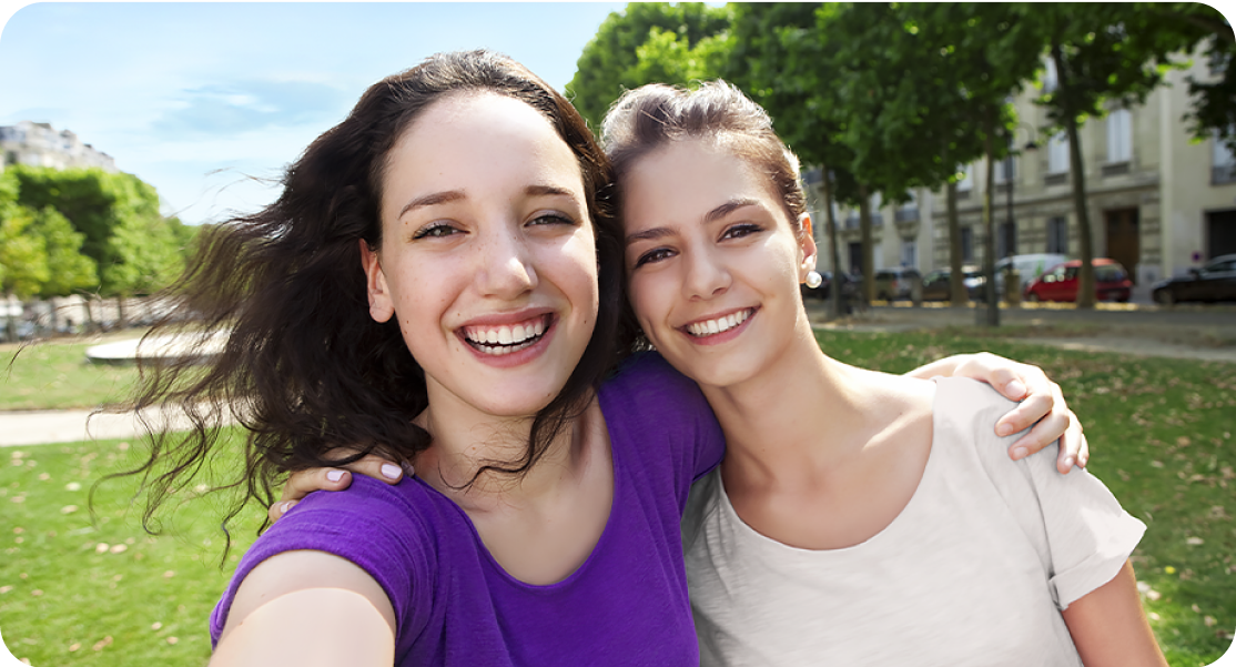Image of two women taking a selfie and smiling.