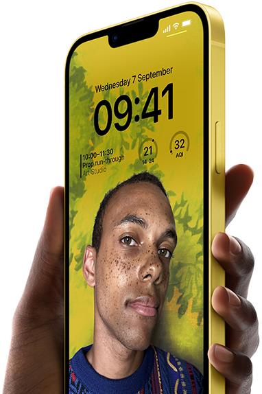 A hand holding an iPhone 14 Plus in yellow displaying a personalised Lock Screen.