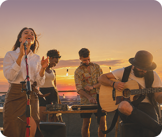 A low-light outdoor photo of several musicians performing at sunset, showing clear, vivid details with Nightography.