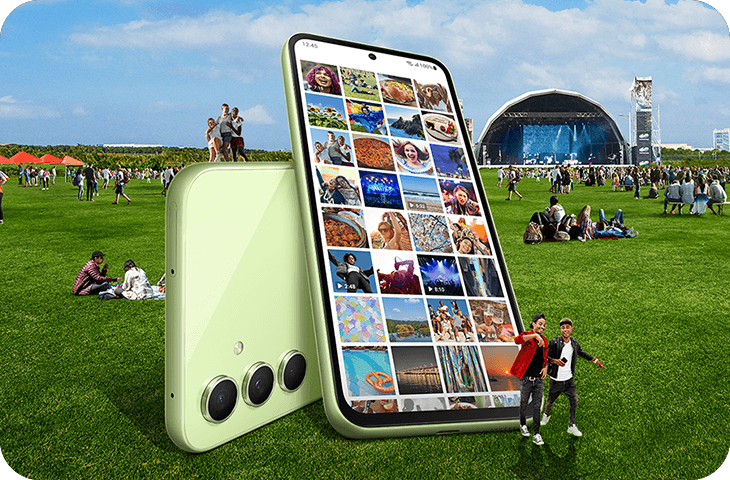 A composite image of two giant A54 5G devices in a field at a music festival