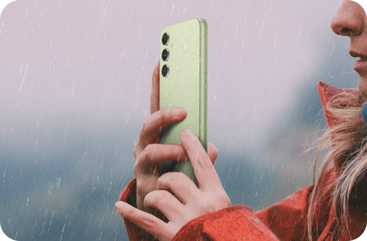 A woman using her A54 5G to take pictures in the rain