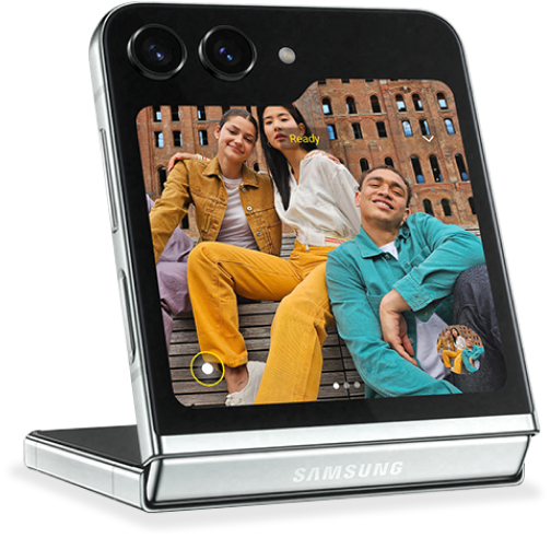 A Galaxy Z Flip5 device open in flex mode showing a group selfie on the cover screen