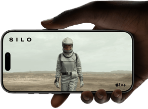 A hand holds an iPhone 17 Pro, Silver, horizontal, video playback on all-screen display demonstrating battery life