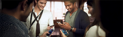 A group of people using their smartphone