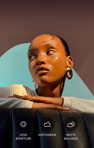 Close-up portrait of a well-lit model with a colourful background, demonstrating the Pro camera system's Pro controls UI: Aperture, Histogram, White Balance