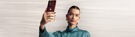 A woman taking a selfie with the Motorola Edge 70 Pro